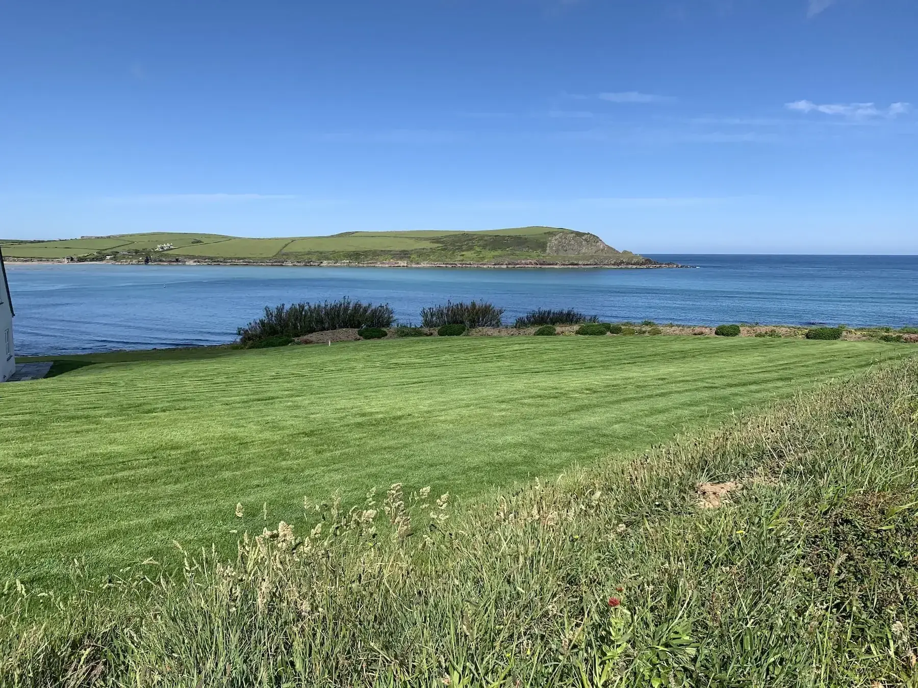 Coastal holiday property lawn with a view of the beach